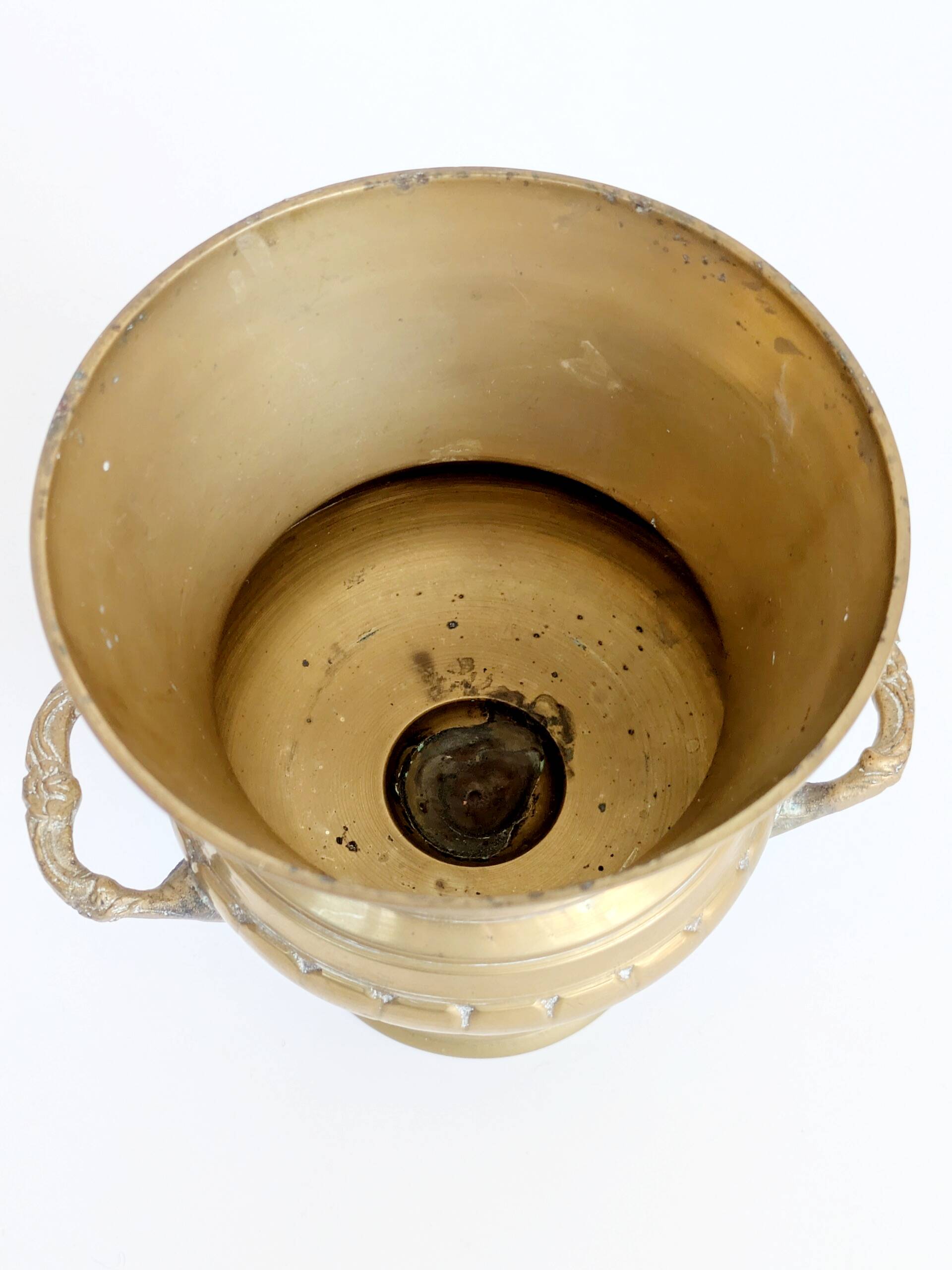 Vintage brass cache-pot on a stand with handles, classic decor.