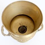 Vintage brass cache-pot on a stand with handles, classic decor.