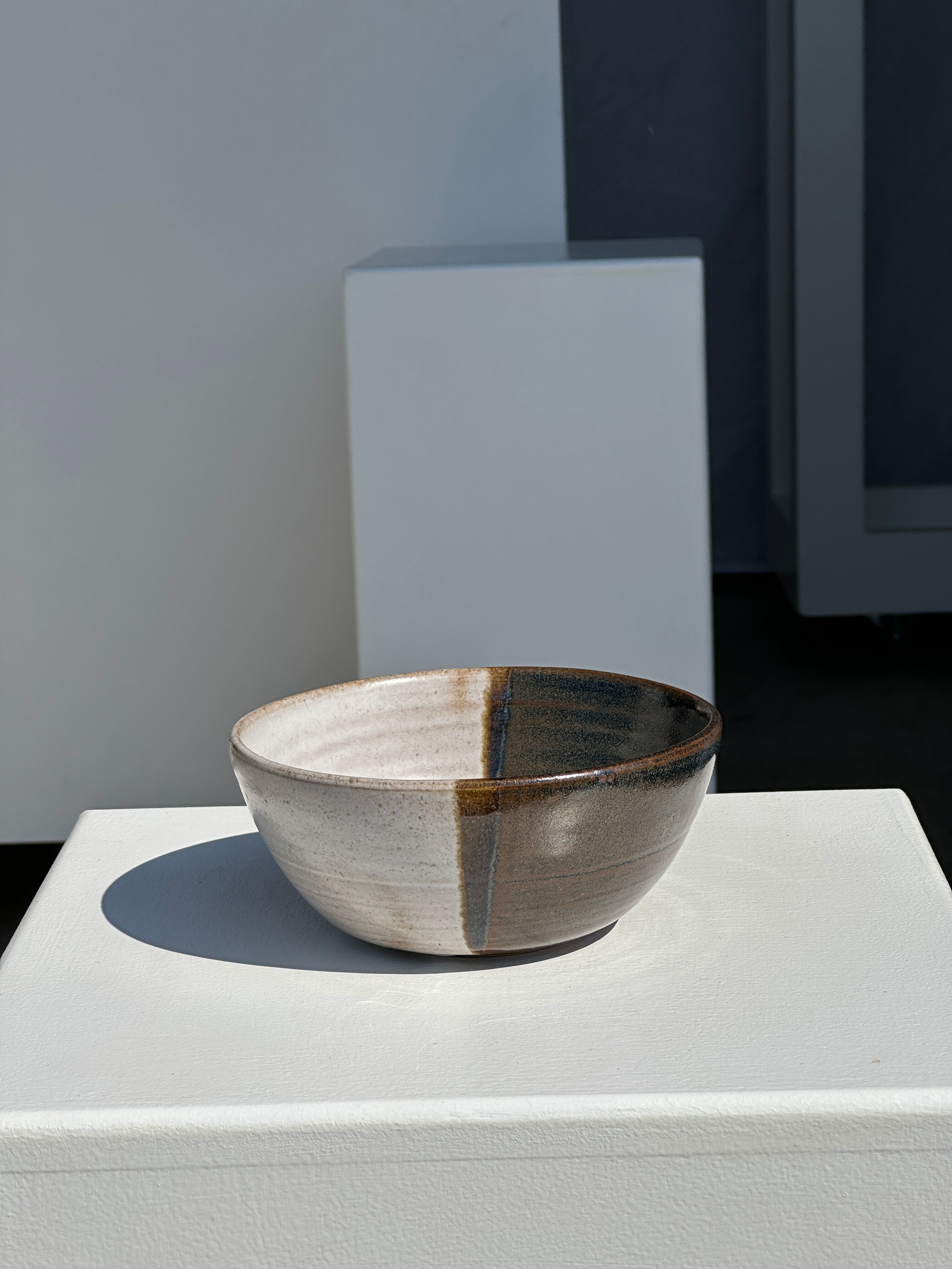 White and glossy brown two-tone ceramic bowl, matt earth