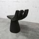 Black armchair chair in carved wood in the shape of a hand