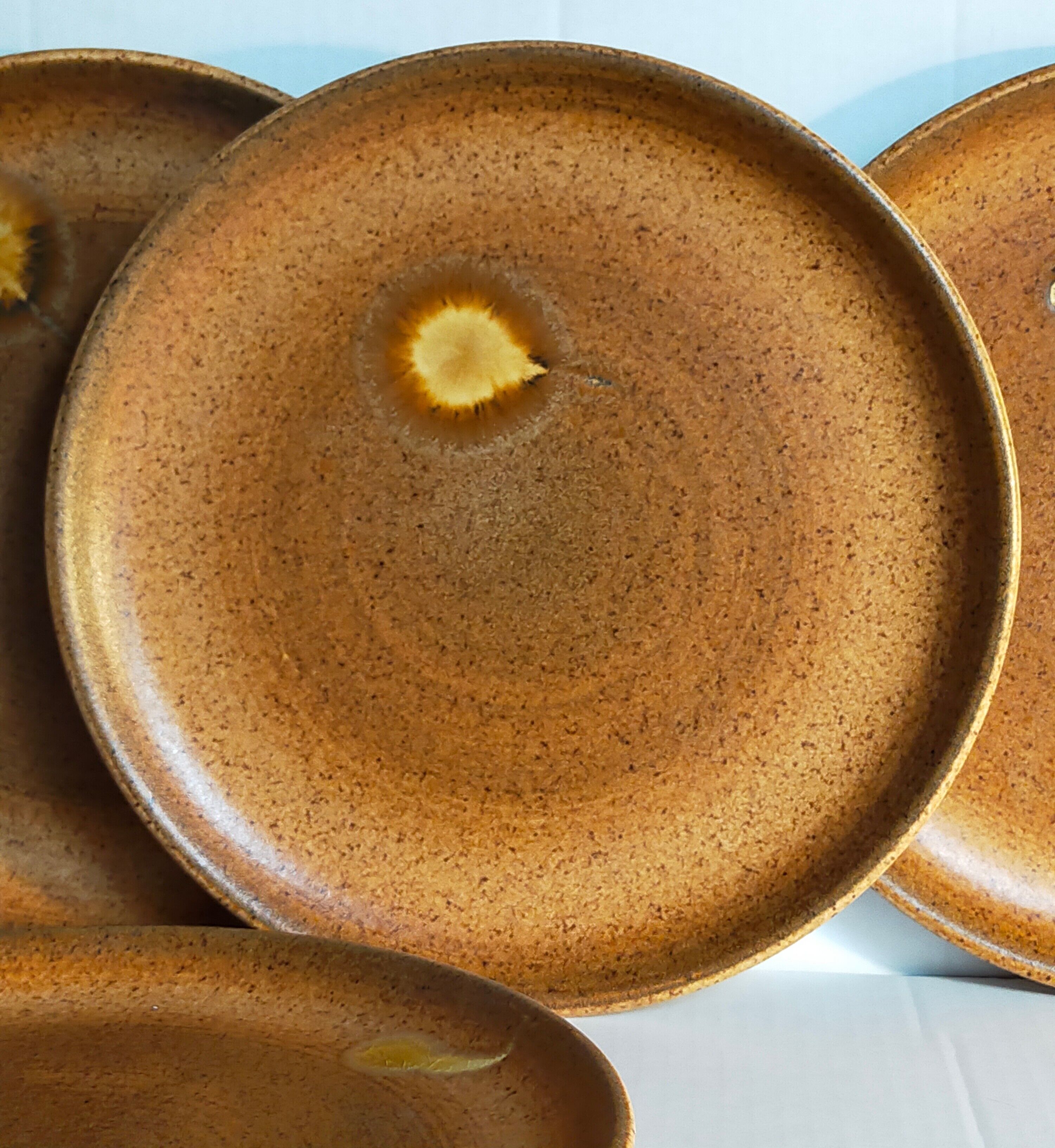 Four vintage glazed stoneware potter's plates