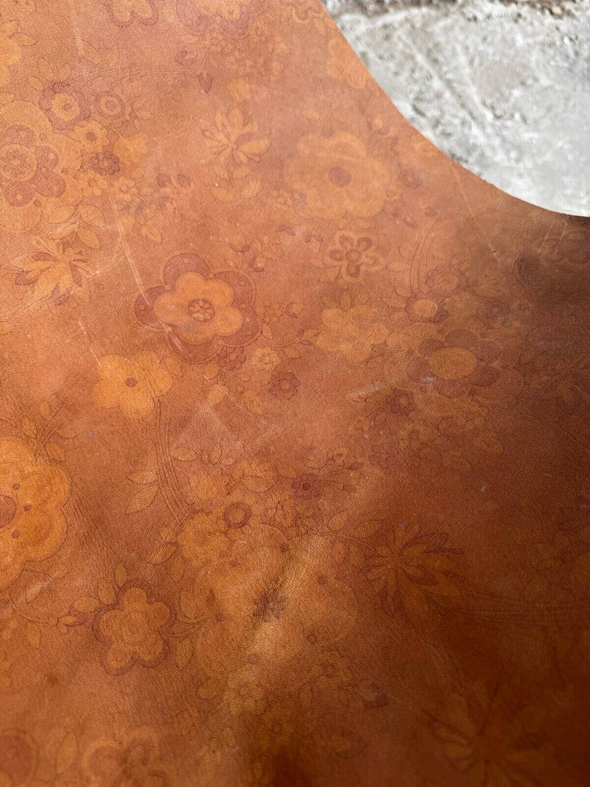 19th-century dark brown wrought-metal rocking chair with cognac leather sling seat, vintage