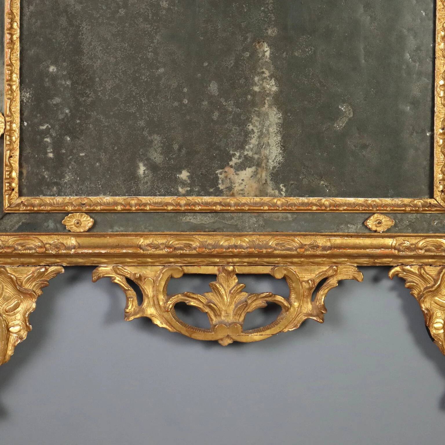 Antique gilded wooden mirror with rococo patterns, Italy, 18th century.