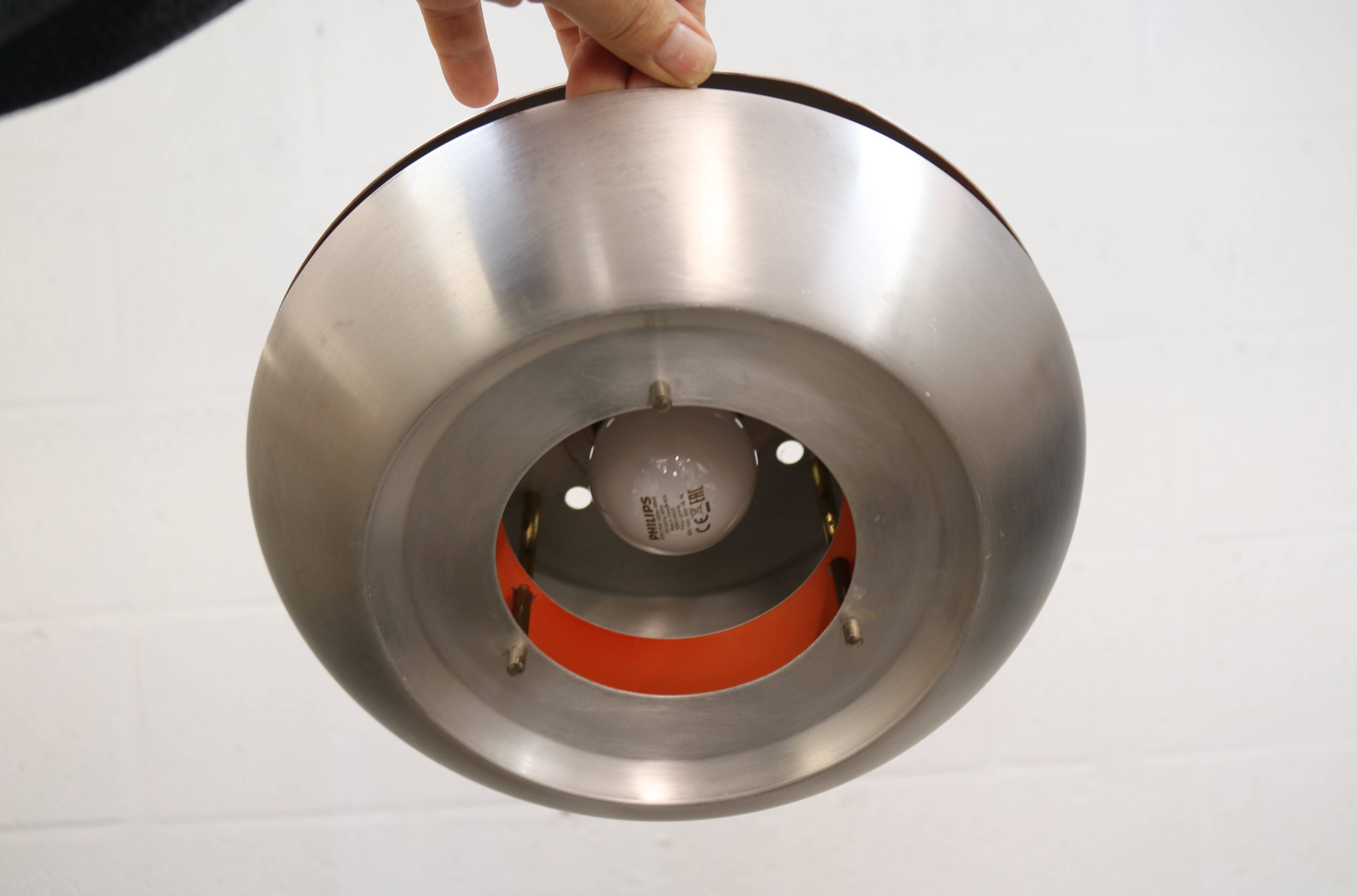 Old Danish space age design lamp in alu and orange inside.