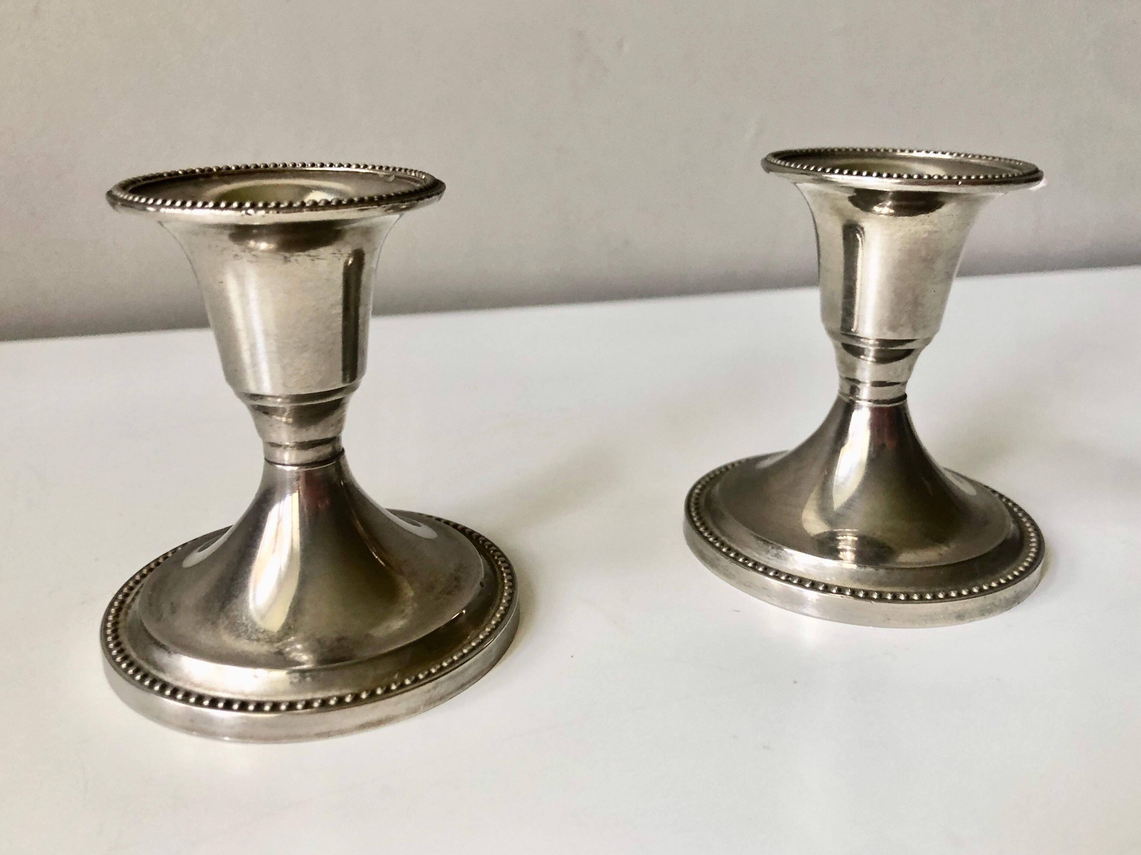 Pair of silver metal candle holders