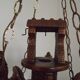 French vintage Breton chandelier with hand-carved figures, well, and lantern lights.