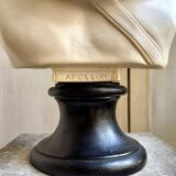 Beige bust of Apollo on black pedestal