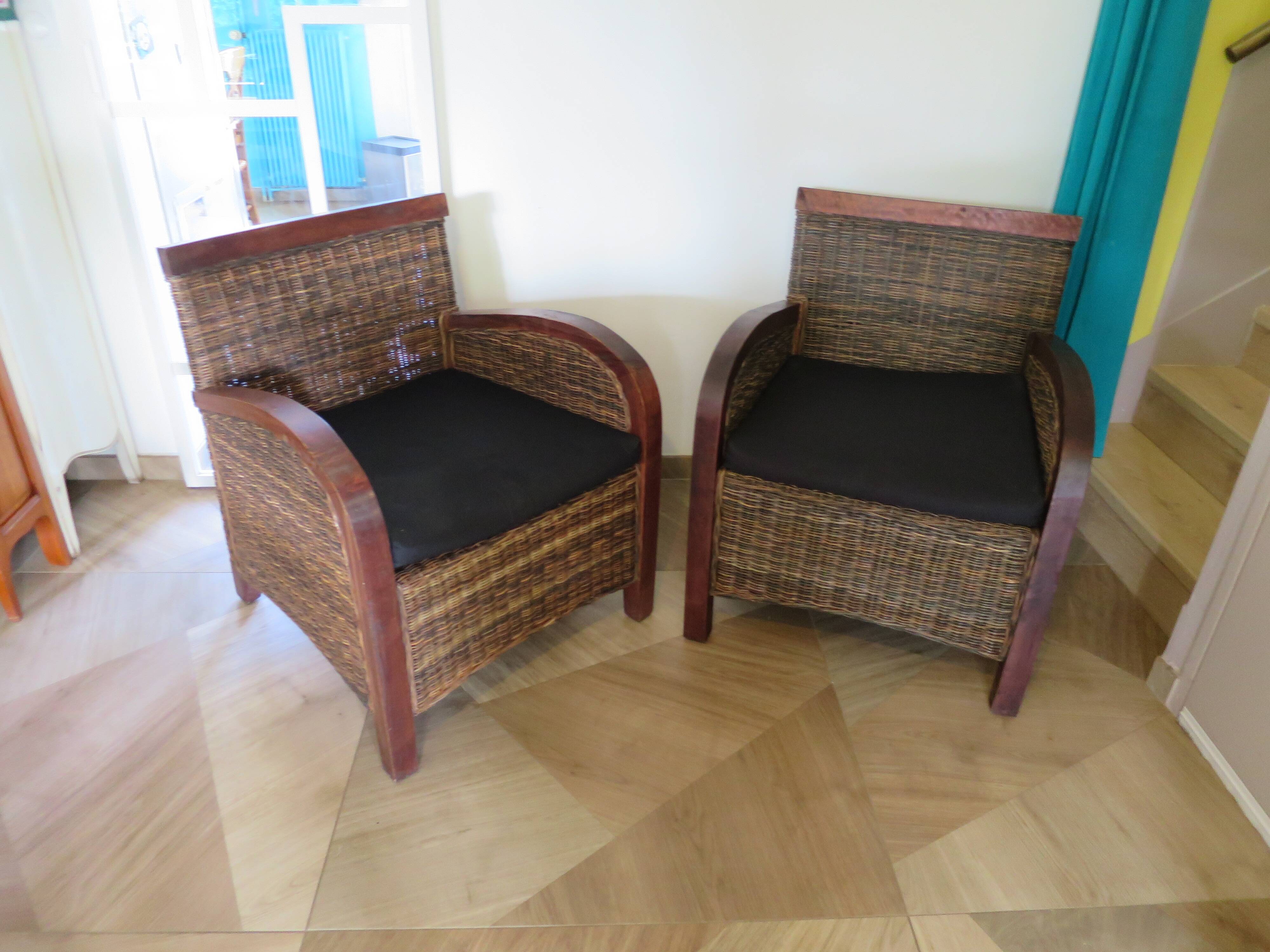 2 colonial-style armchairs in woven rattan and exotic wood