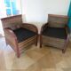 2 colonial-style armchairs in woven rattan and exotic wood
