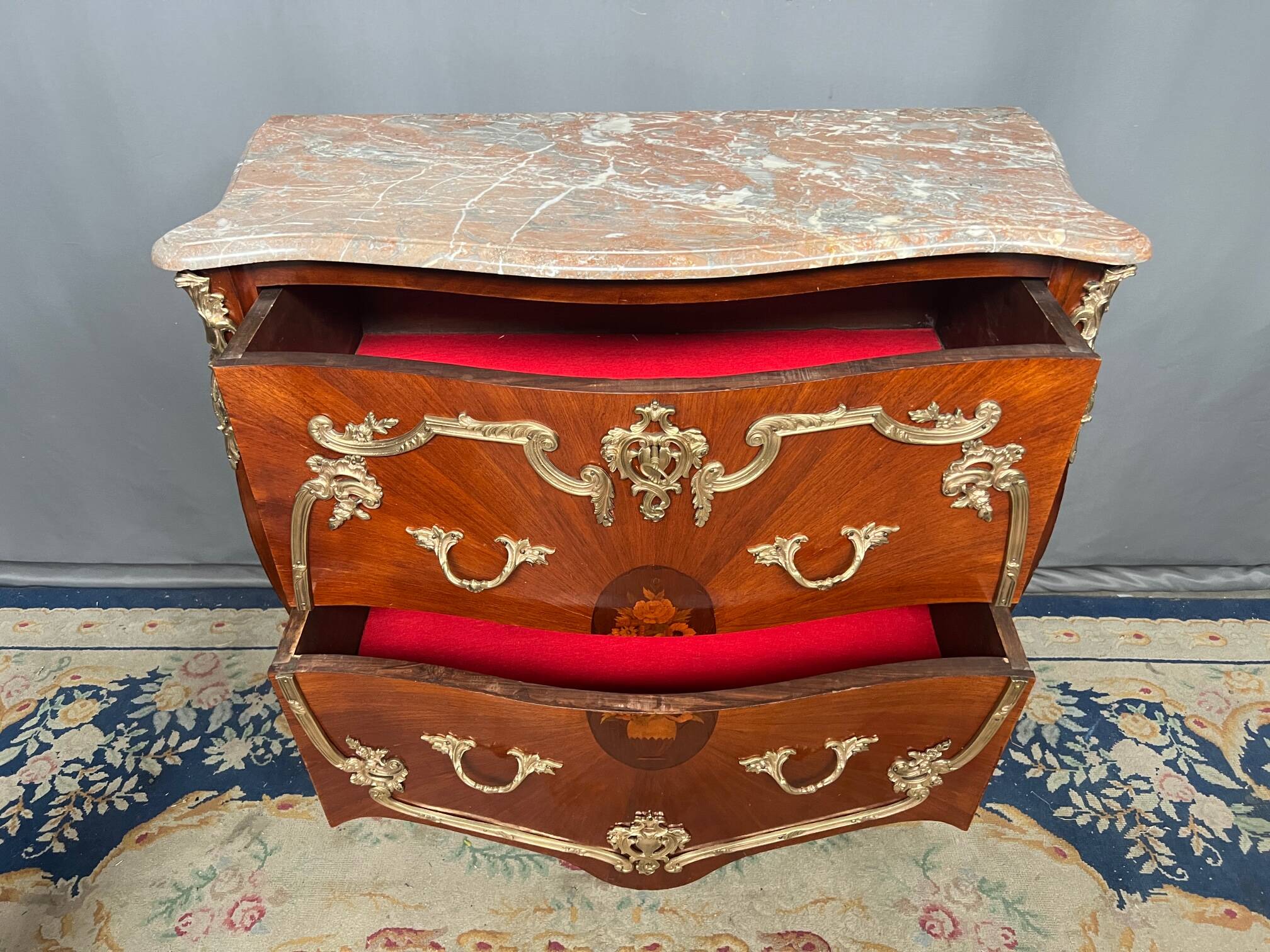Louis XV style commode. Marquetry, gilded bronze decoration.