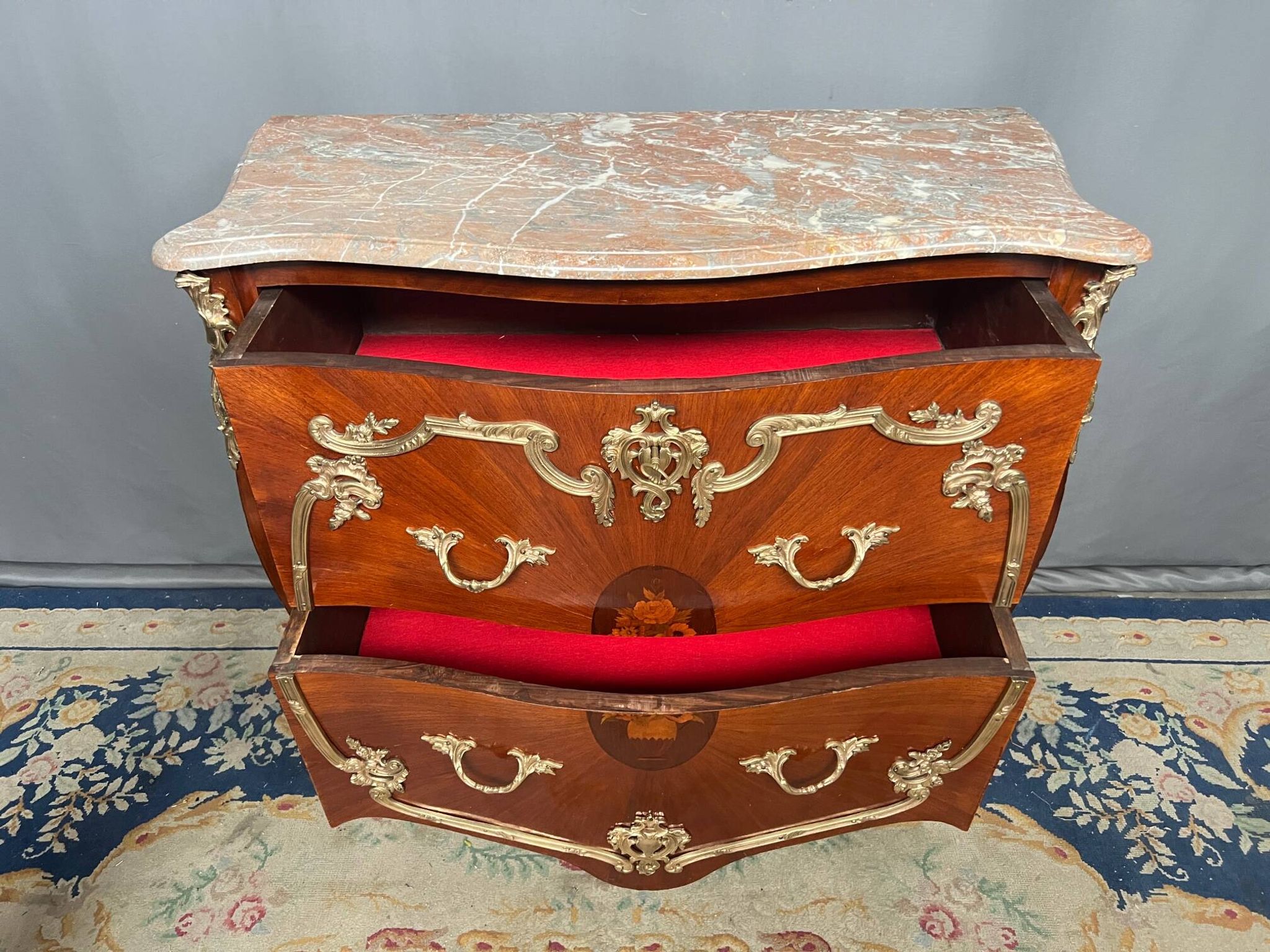 Louis XV style commode. Marquetry, gilded bronze decoration.