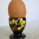 Black egg cup with hand-painted floral decoration
