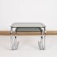 Pair of nesting tables in smoked glass and chrome legs.
