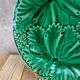 Set of 2 green earthenware dessert plates with vine decoration.
