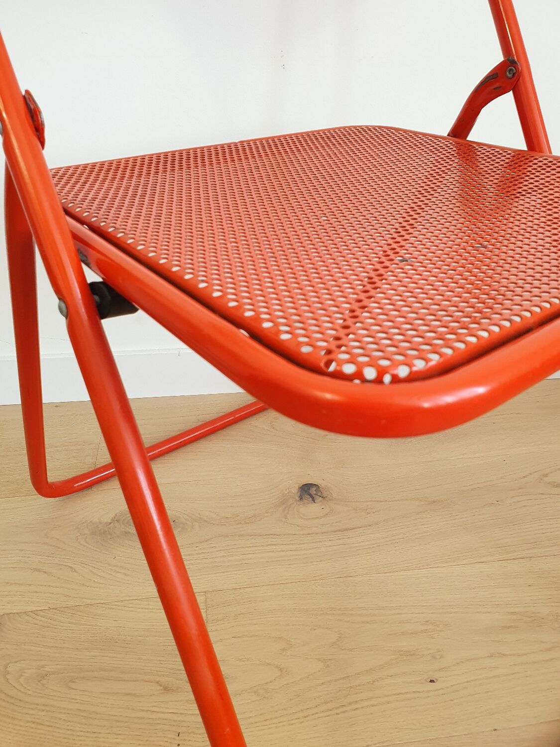 Perforated metal folding chair