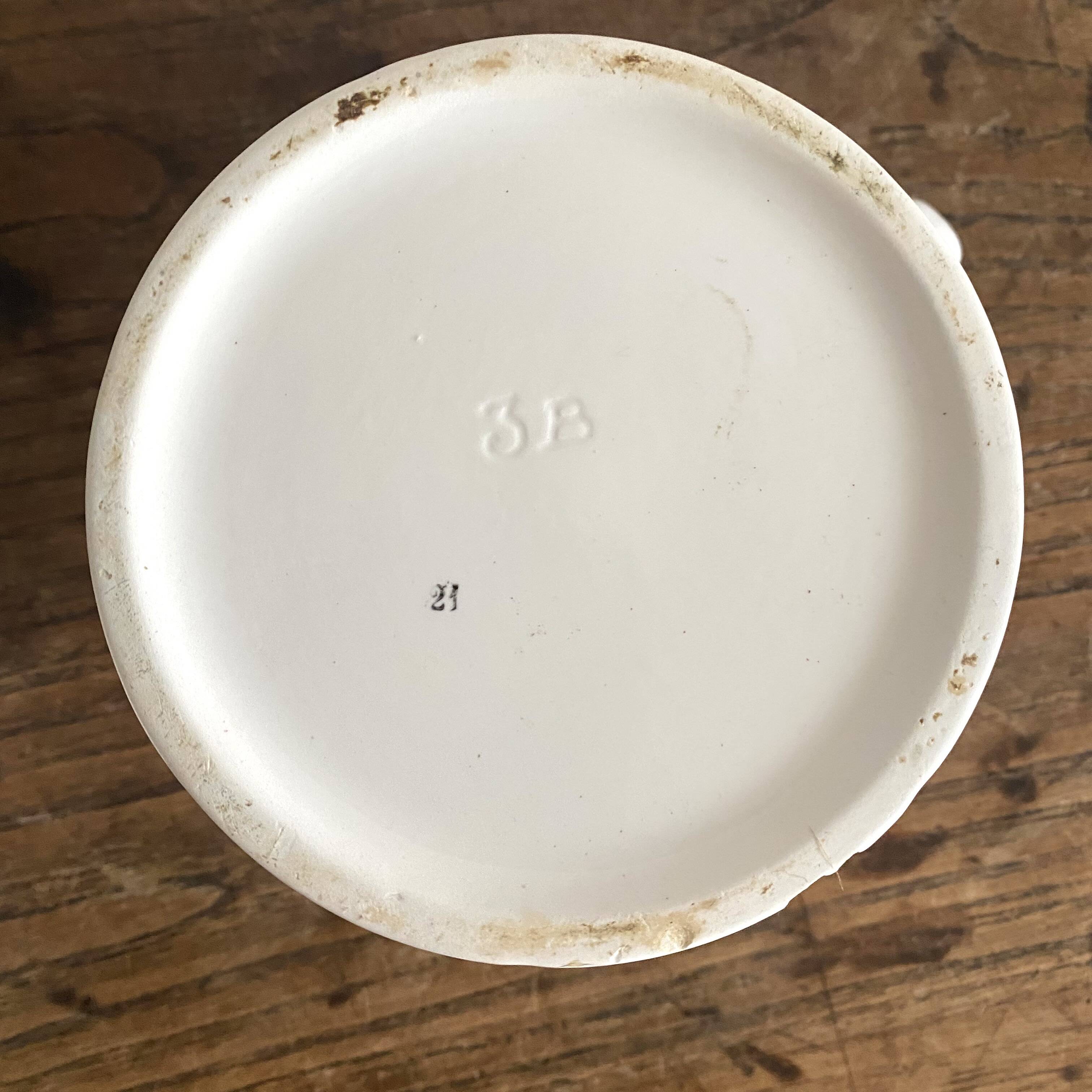 Antique earthenware pitcher with burgundy stripes