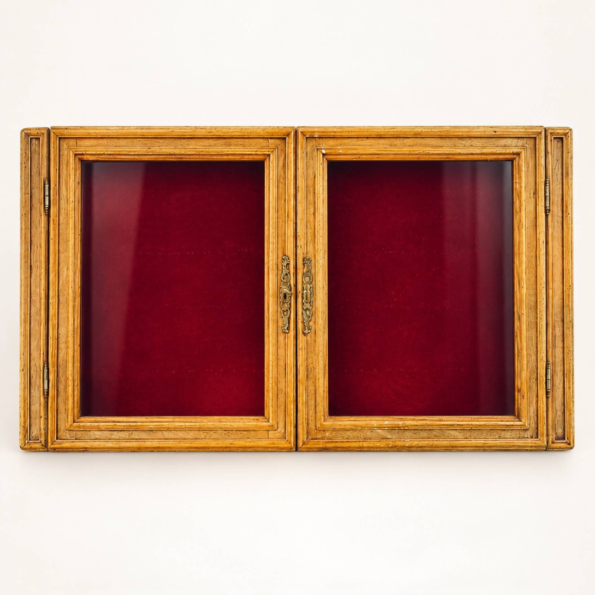 Vintage wall display cabinet in moulded wood and glass – burgundy background