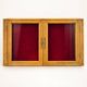 Vintage wall display cabinet in moulded wood and glass – burgundy background