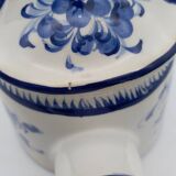 Earthenware watering can vase with floral decoration. St Clement.