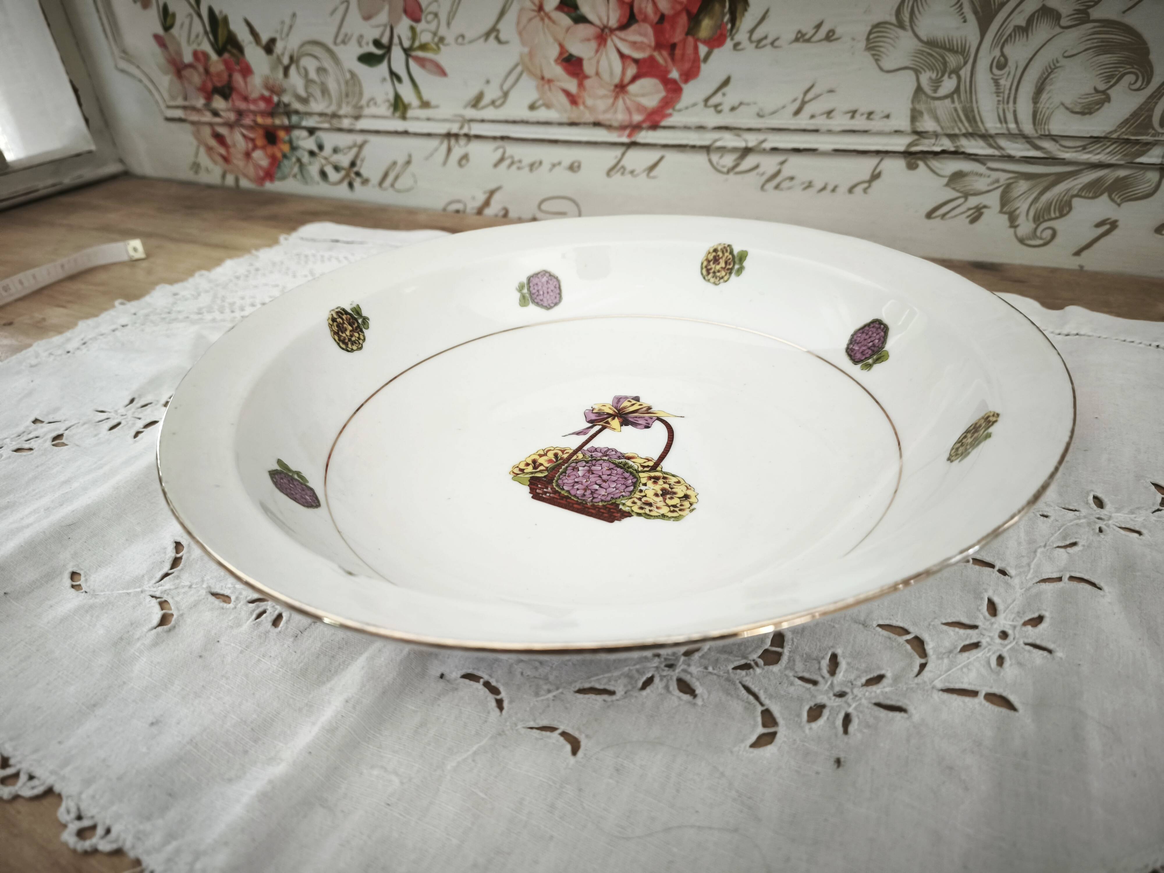 Shallow round plate in Limoges porcelain with a hydrangea basket design.