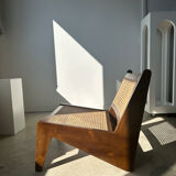Reclined armchair in canned teak in natural wood