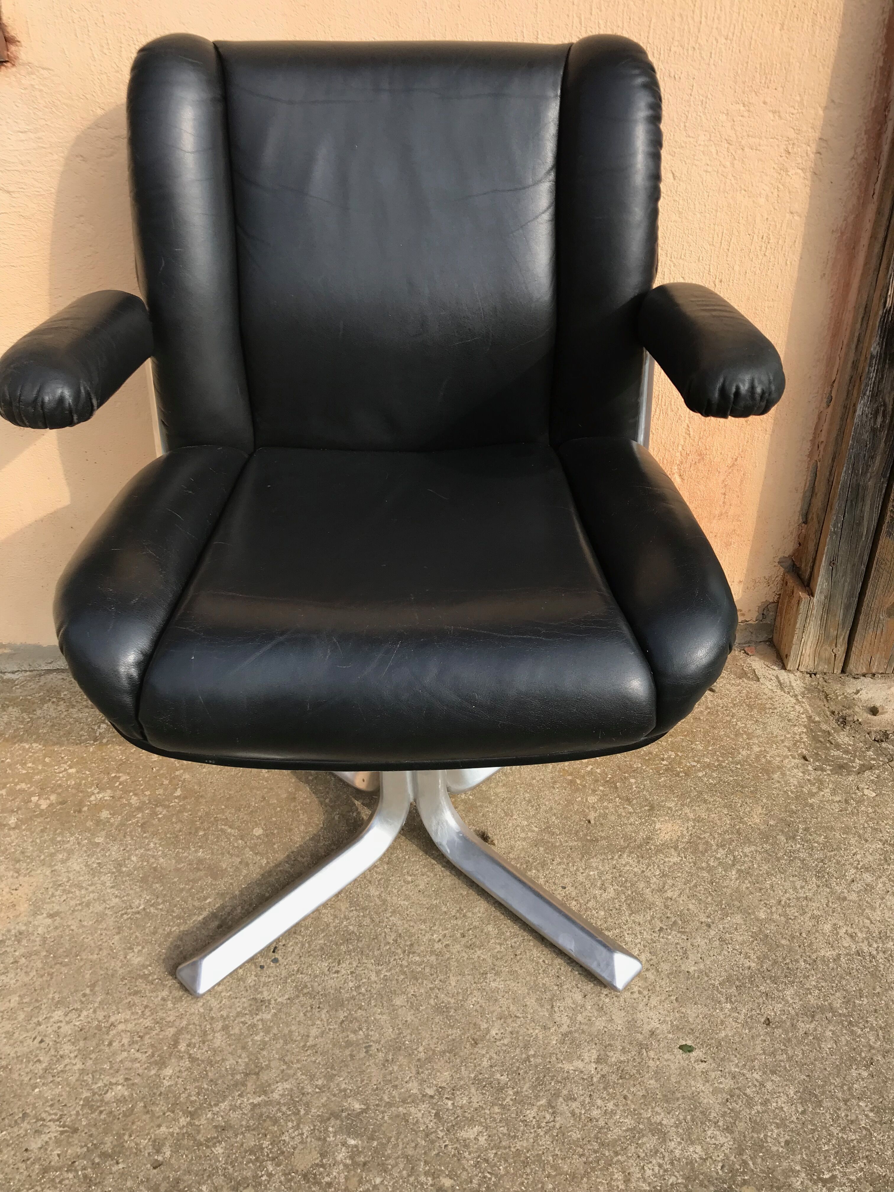 Vintage swivel black leather armchair
