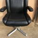 Vintage swivel black leather armchair