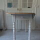 Oval table with beaded grey patinated flaps, wooden tray