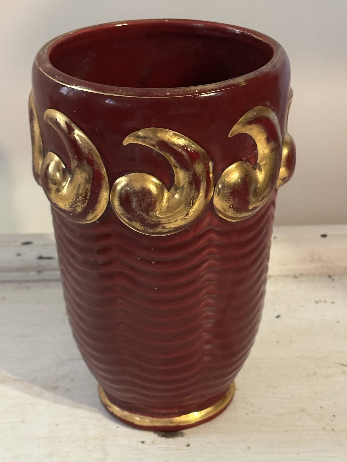 Mid-century relief vase in ruby red enhanced with gilding.