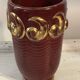 Mid-century relief vase in ruby red enhanced with gilding.