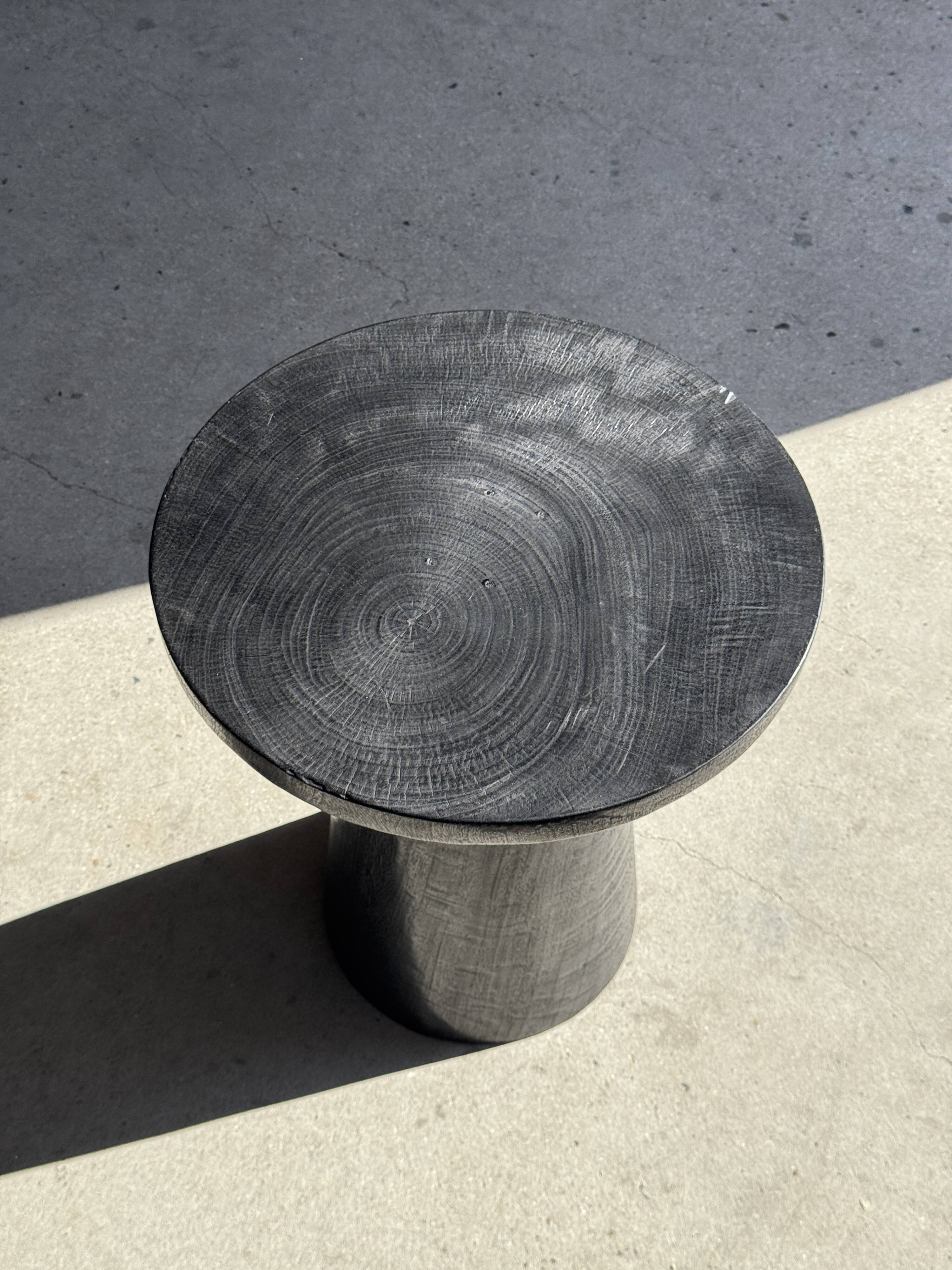 Black solid mango side table (monoxyle) with conical legs