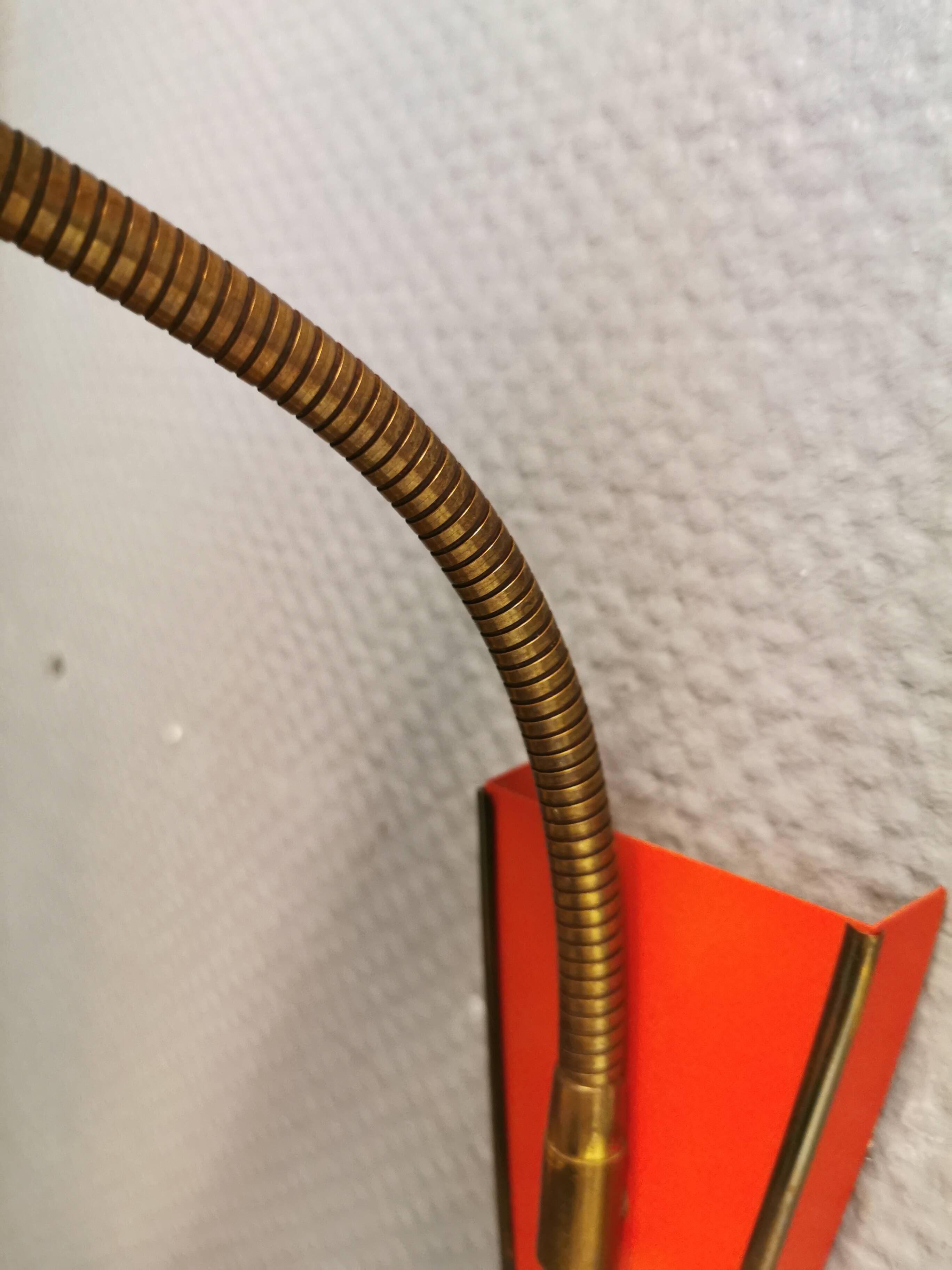 Danish red lacquered wall light with brass details. Estimated 1980s