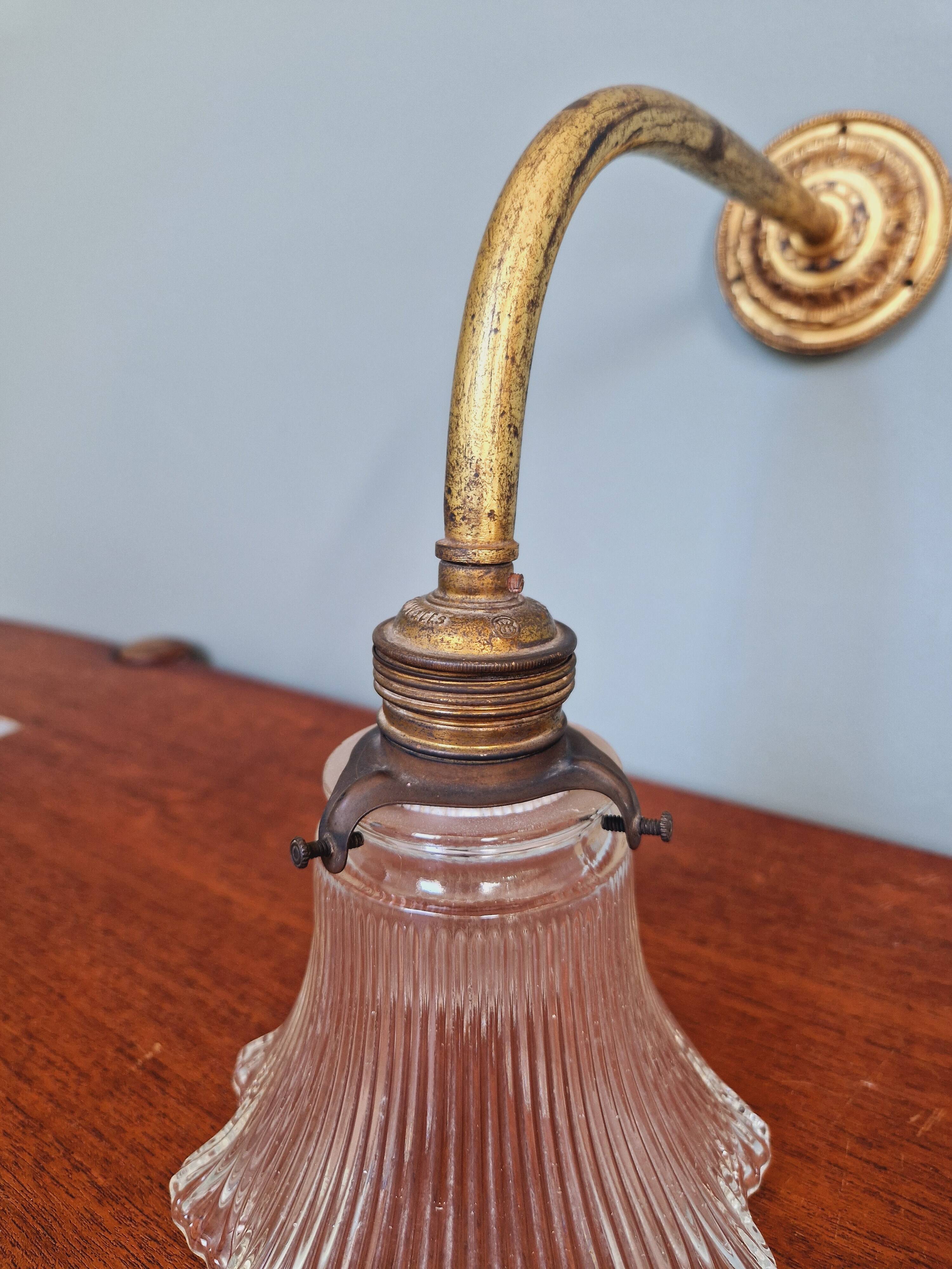 Bronze wall light with grooved clear glass, early 20th century