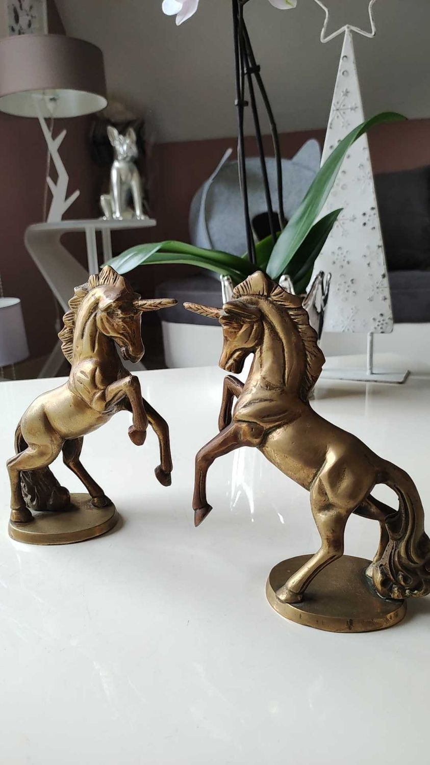 of greenhouse art deco bookends recancing unicorns. solid brass