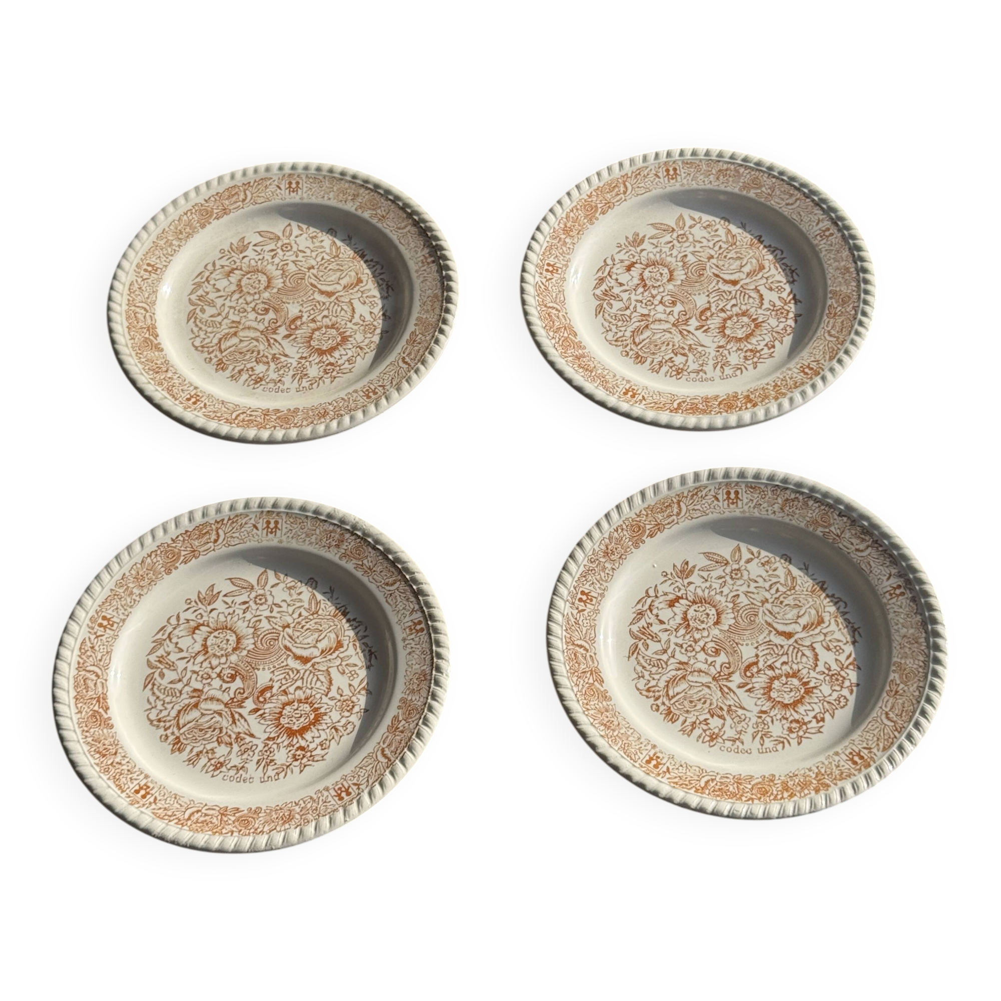 Set of 4 small dessert plates with a vintage stylised flower pattern.
