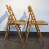 Pair of vintage wooden folding chairs with star pattern on seat
