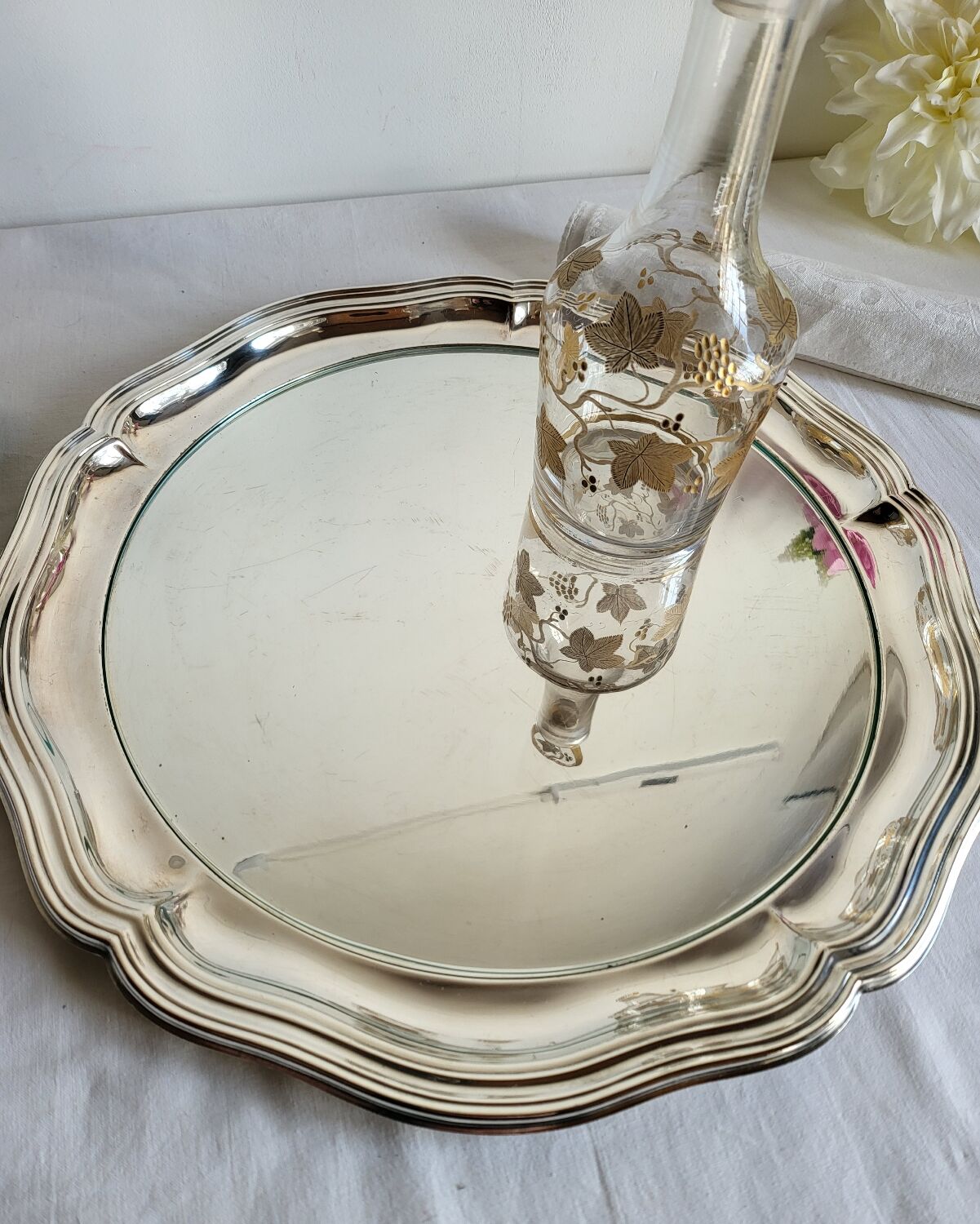 Round silver-plated serving dish with a glass base.