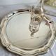 Round silver-plated serving dish with a glass base.