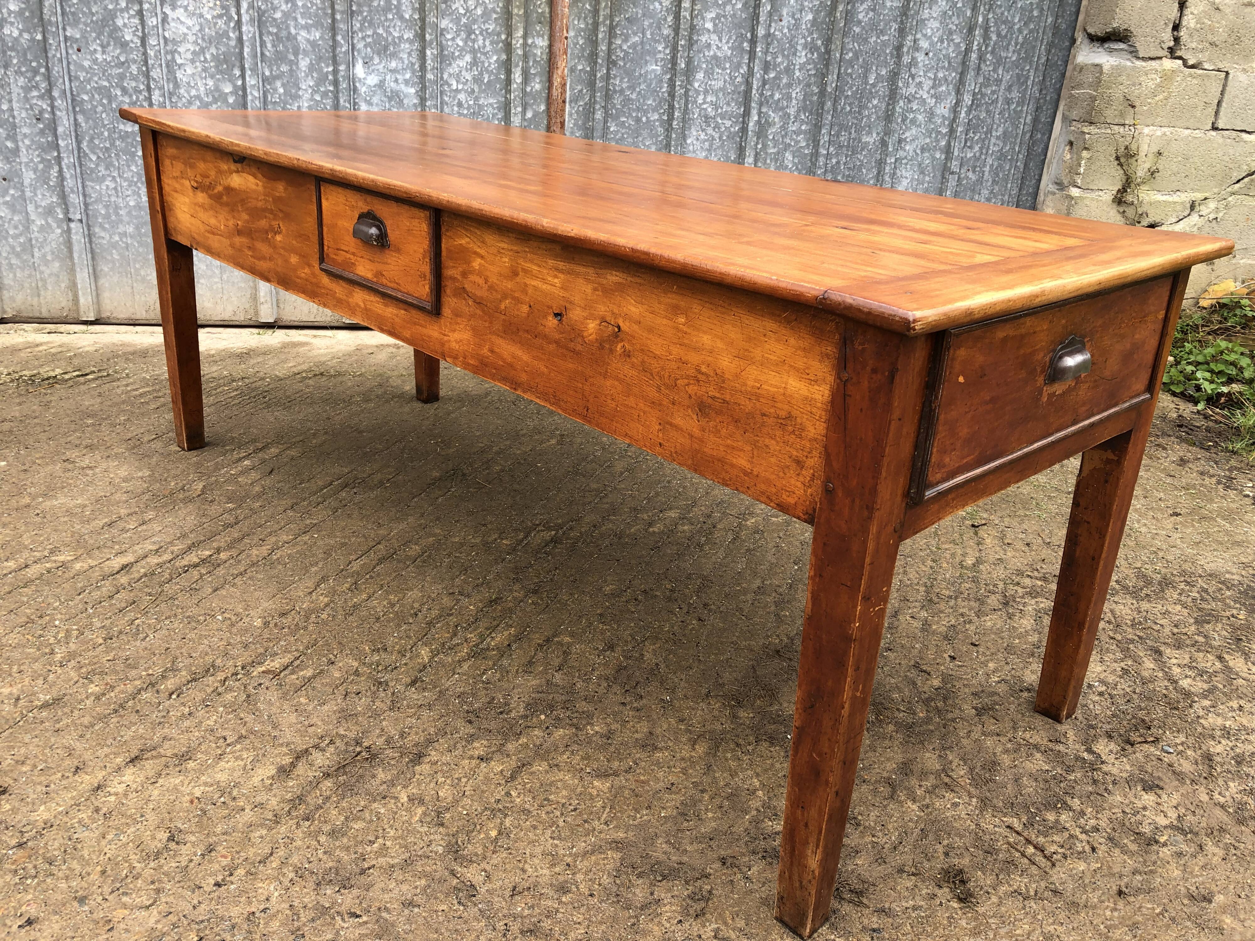 Antique farmhouse table in solid cherry wood with 3 drawers and 1 pull-out.