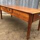 Antique farmhouse table in solid cherry wood with 3 drawers and 1 pull-out.