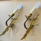 Bronze wall lights in the Louis XV style with curved branches and leaf decorations.