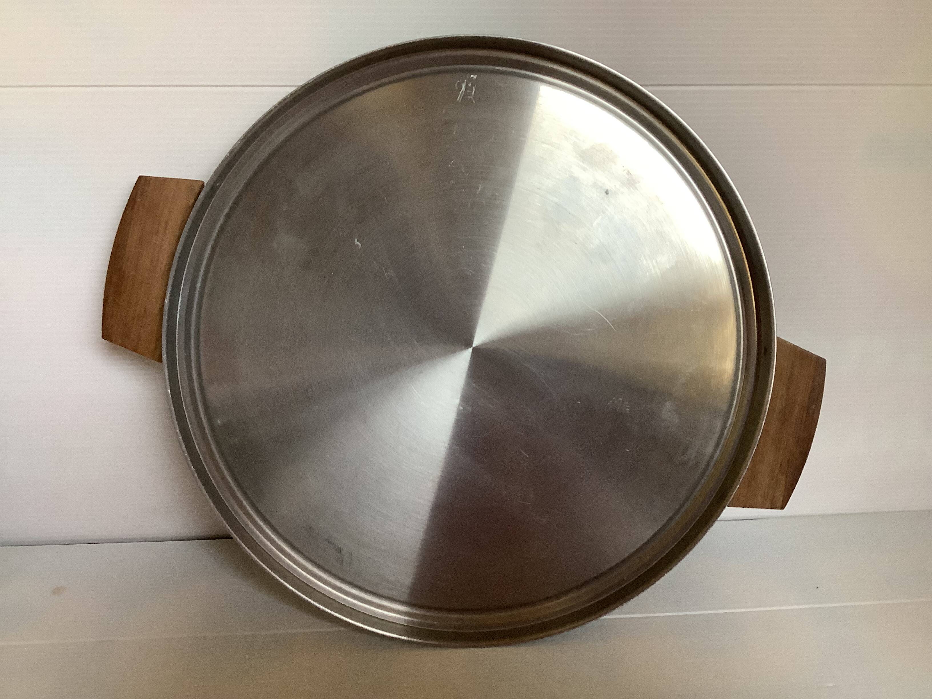 Large flat metal and wood platter in Scandinavian style.