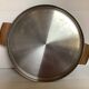 Large flat metal and wood platter in Scandinavian style.