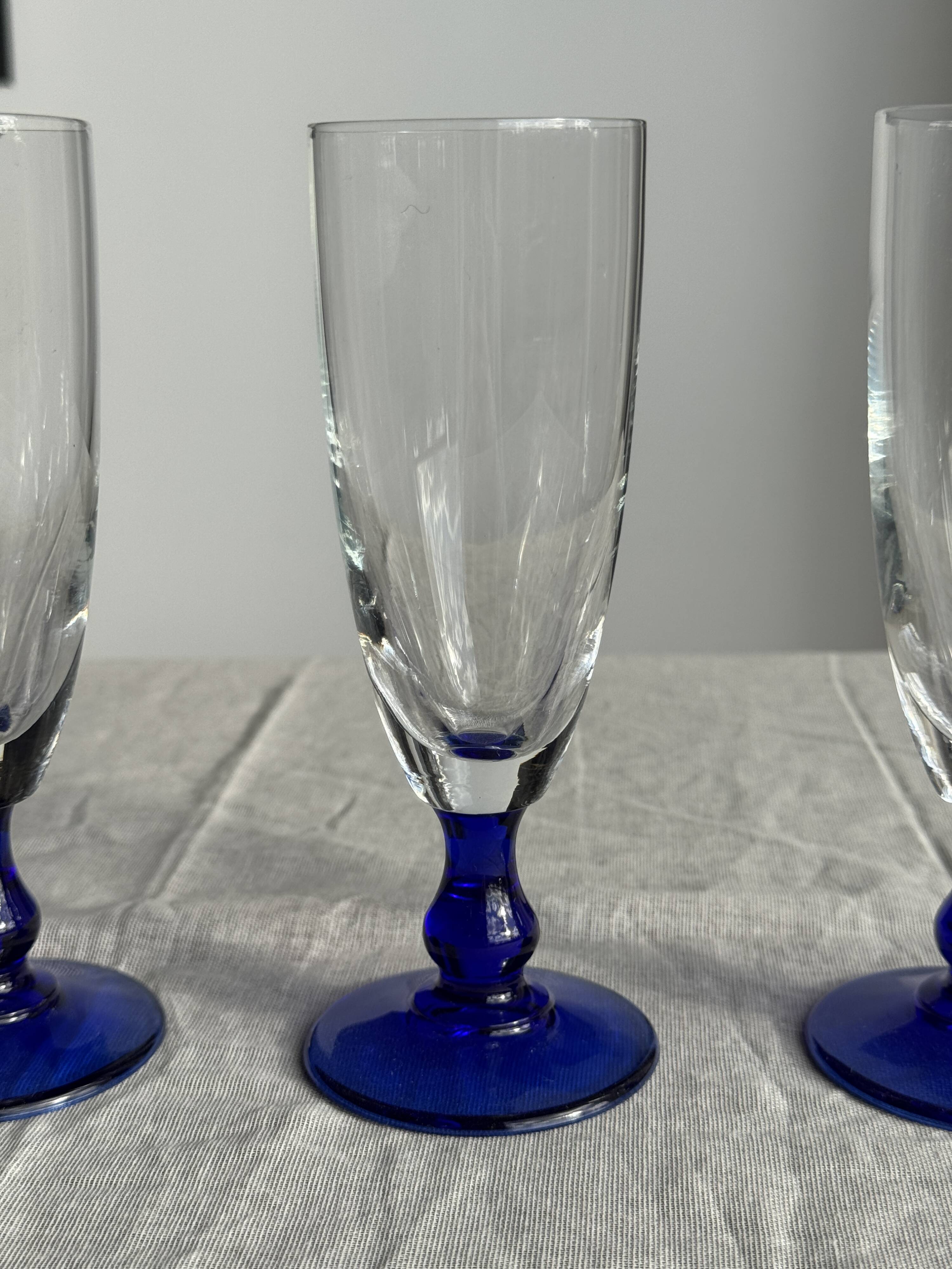Set of 6 blue-footed champagne flutes; 3 pairs of designs.