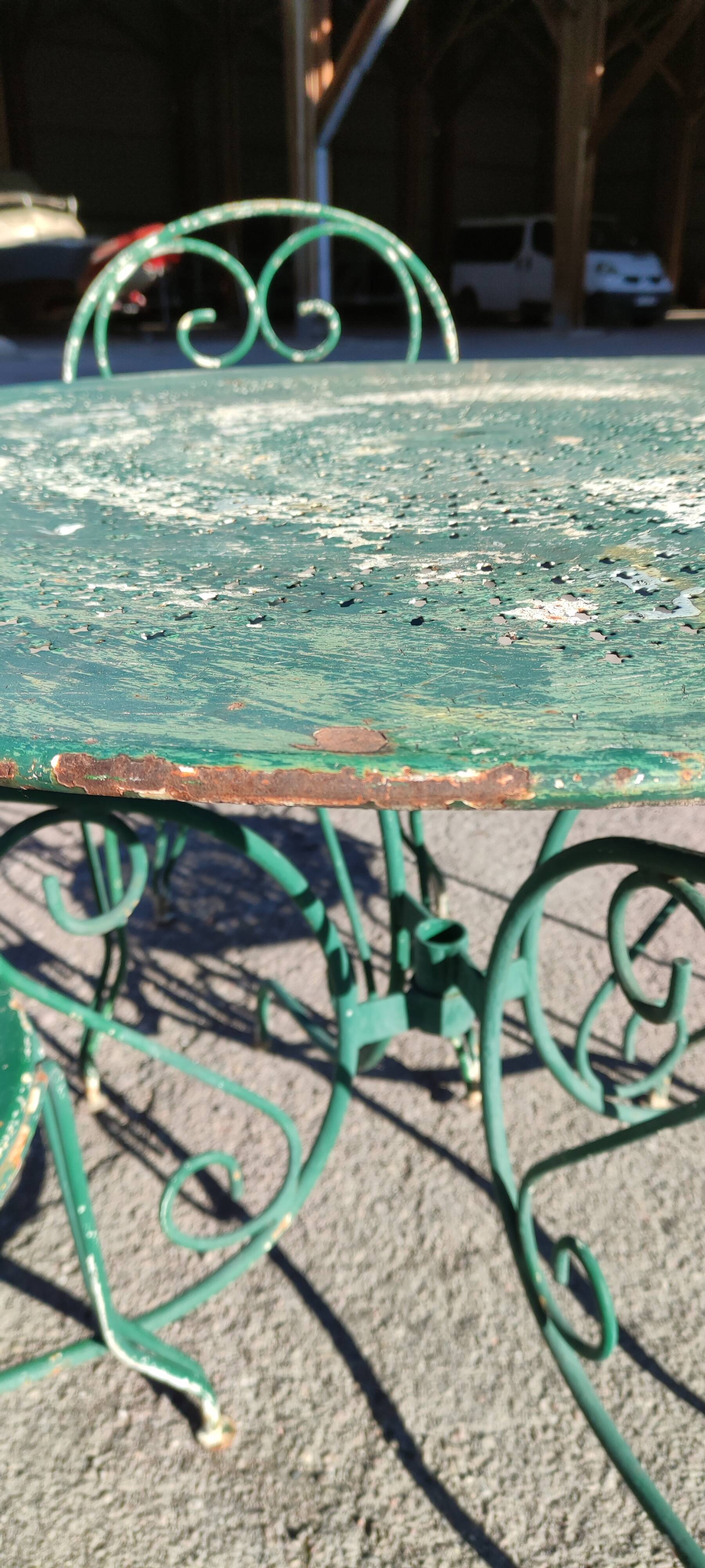 Garden table, two armchairs and a metal chair