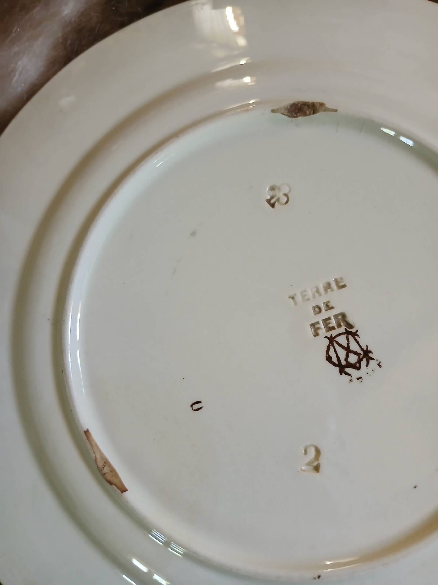 13 mismatched flat plates in ironstone