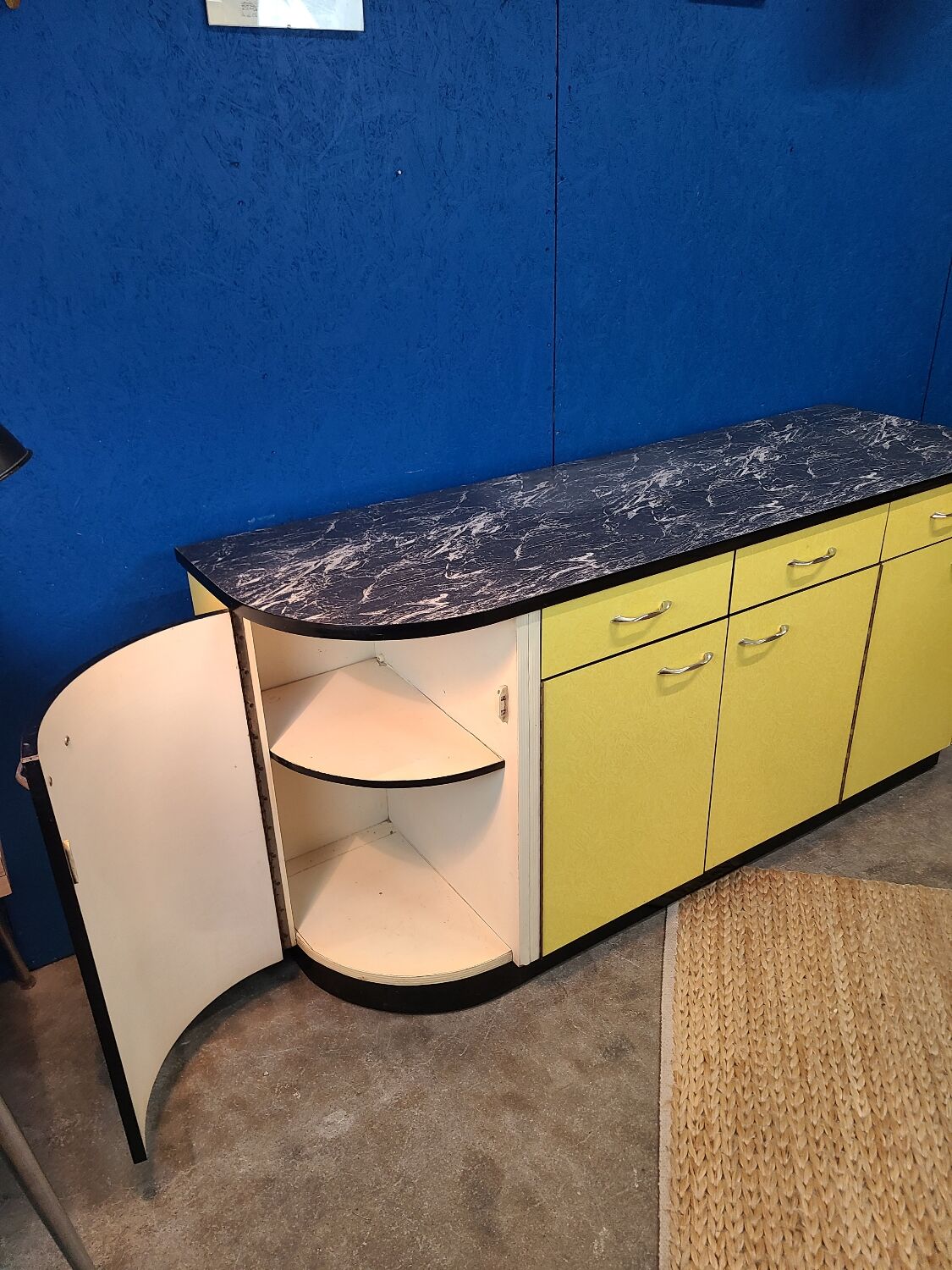 Vintage yellow sideboard, and black marble top.