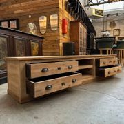 An old piece of workshop furniture transformed into a TV stand