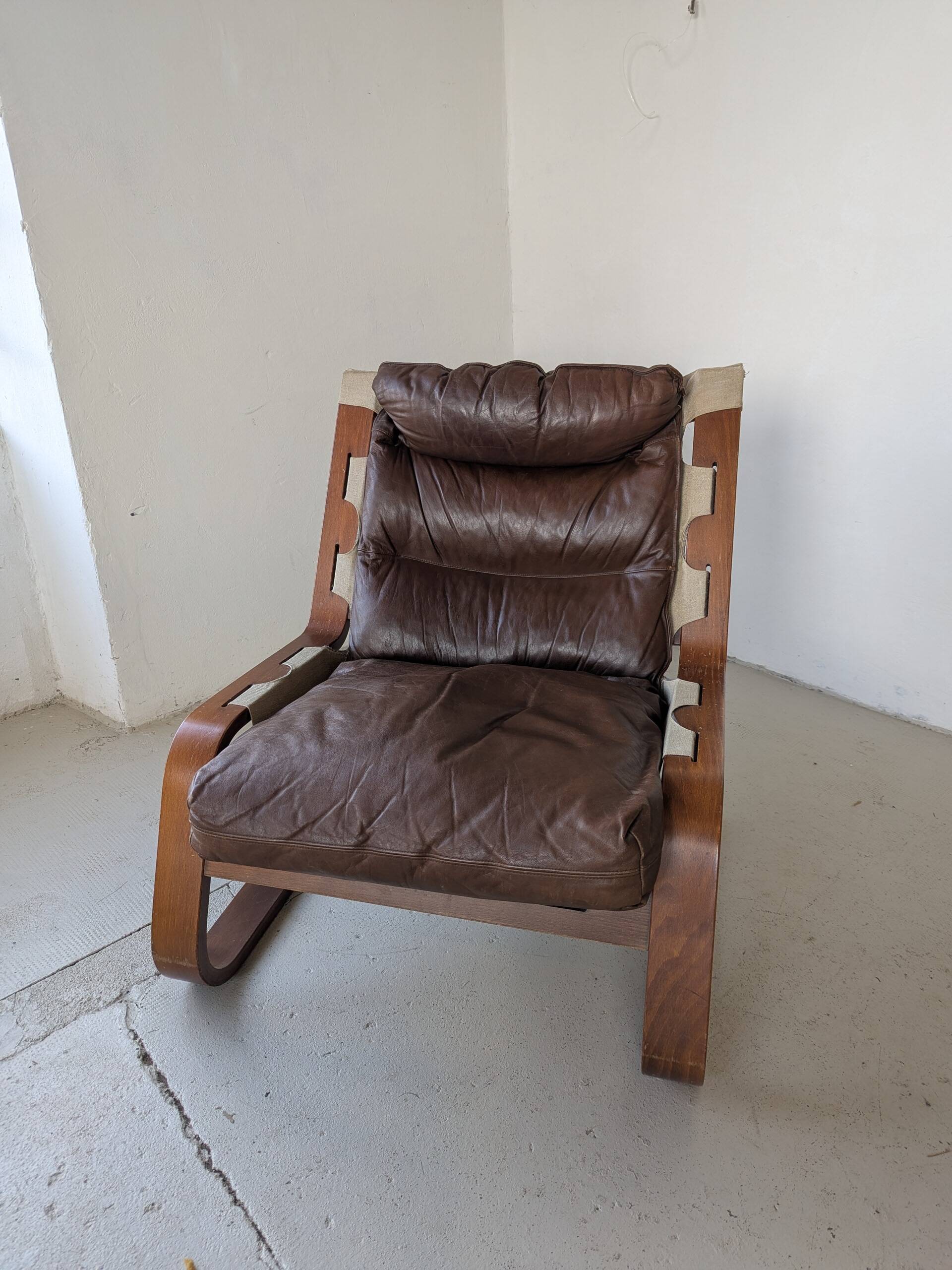 Leather and wood armchair, brutalist style.
