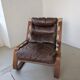 Leather and wood armchair, brutalist style.